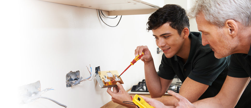 Small business electricians rewiring socket