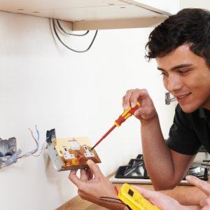 Small business electricians rewiring socket