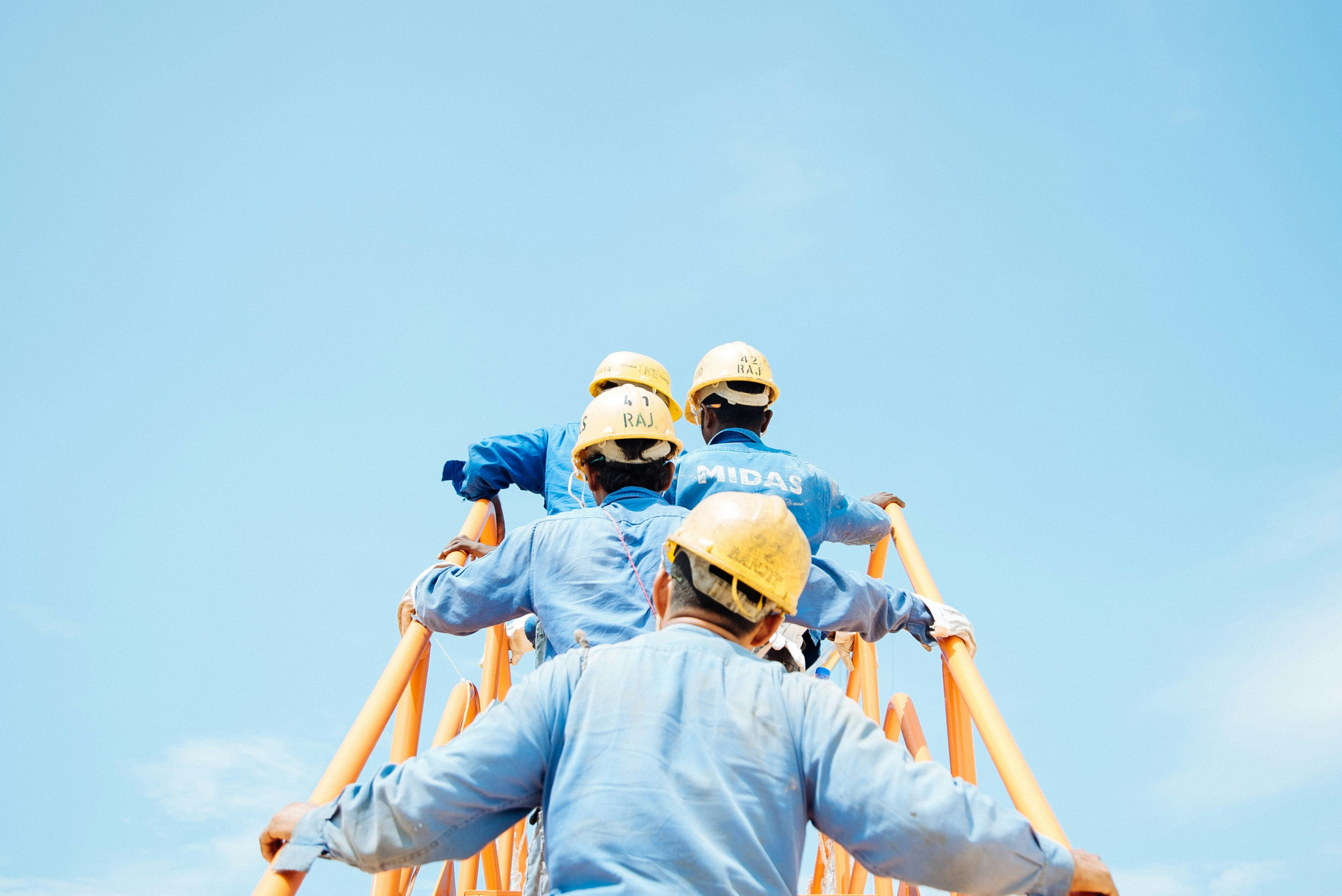 Construction industry workers climbing steps