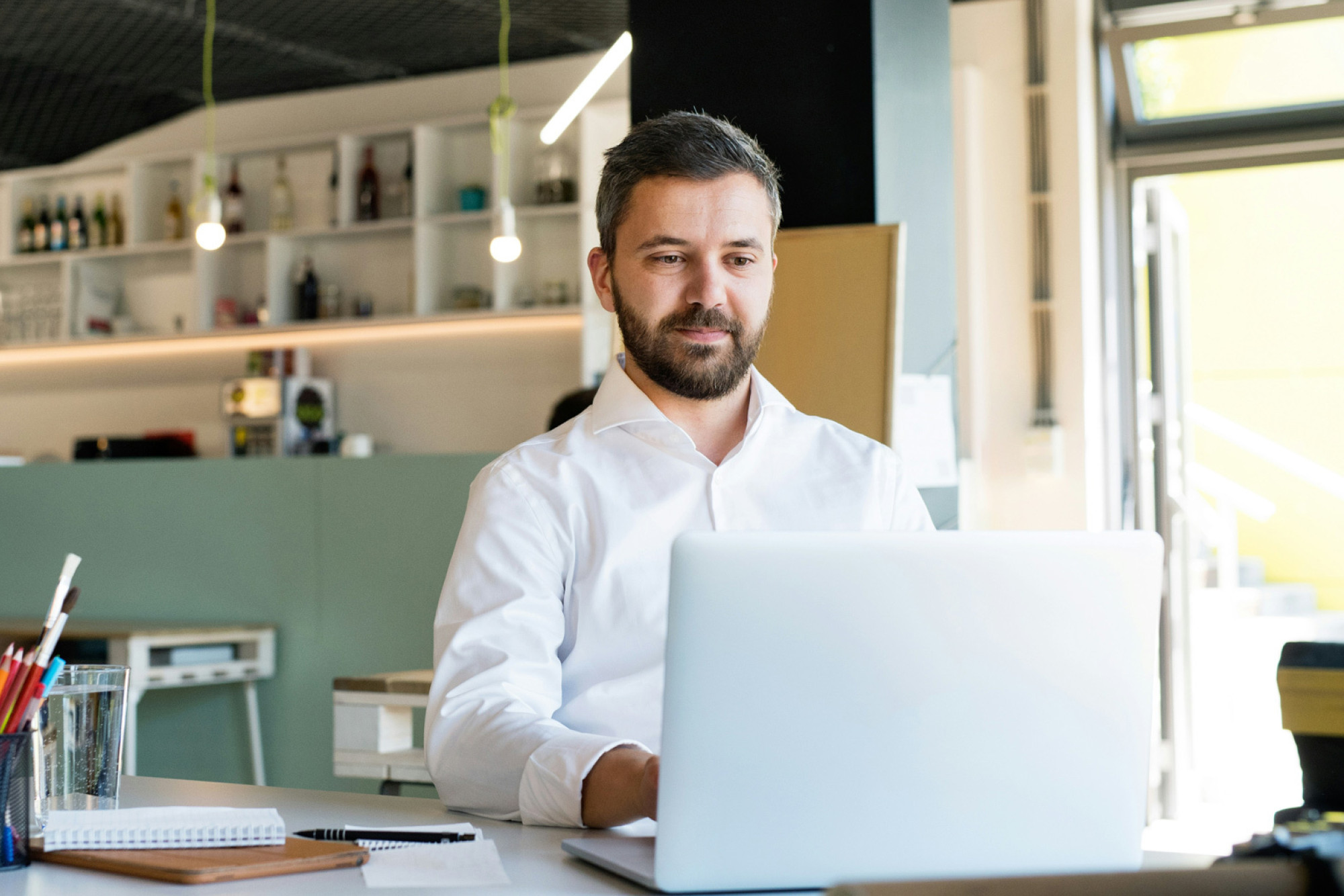 Businessman using a payslip portal on his laptop