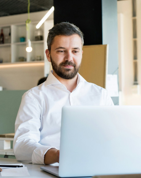 Businessman using a payslip portal on his laptop